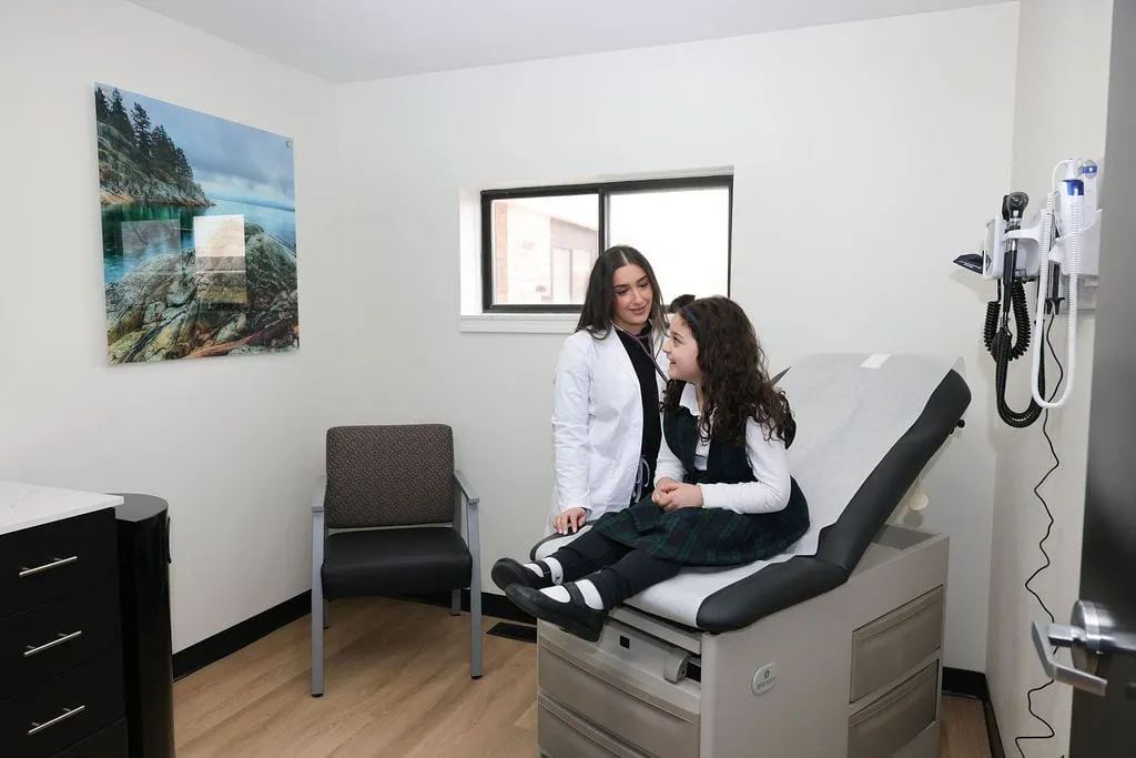 A provider and a patient during a routine visit in a Serenity Urgent Care exam room