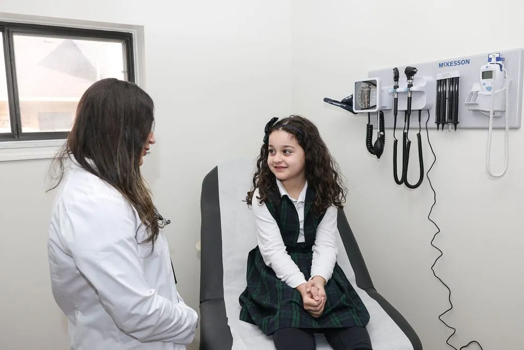 A provider talking with a patient in an exam room at Serenity Urgent Care